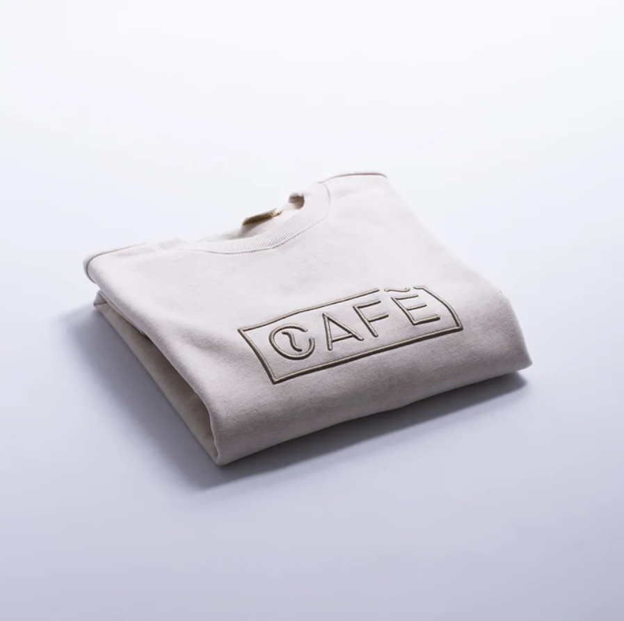 The Café Logo Embroidery Sweater in Ecru Melange